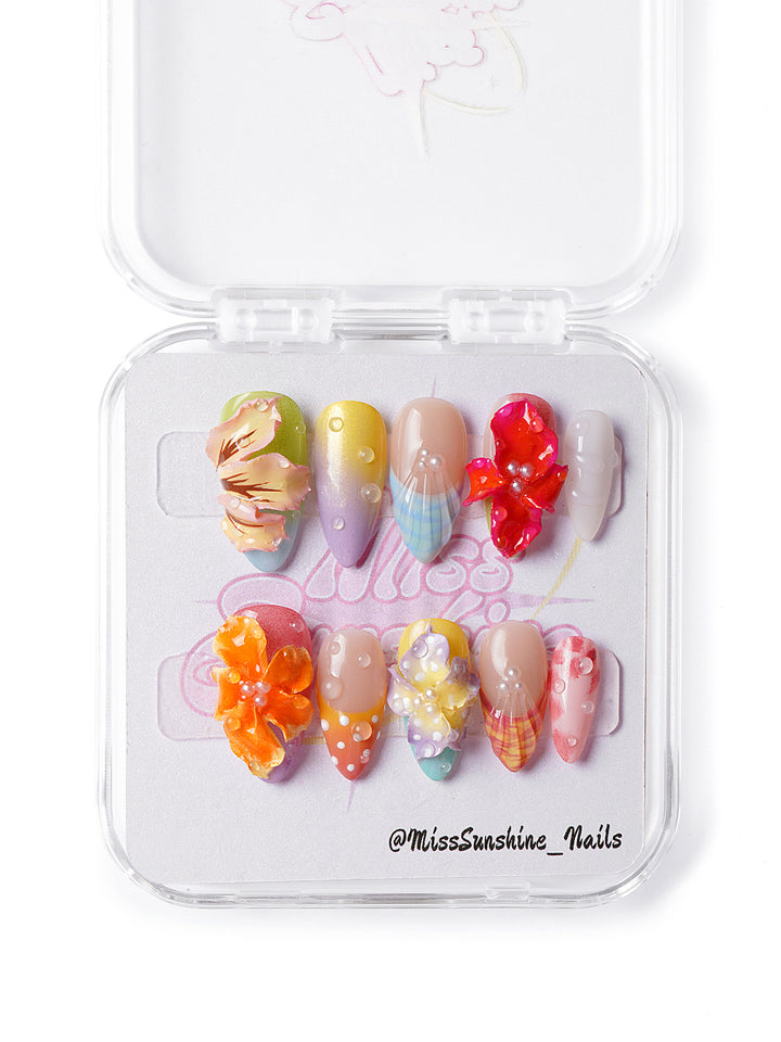 Handmade tropical press-on nails featuring summer colors, polka dots, and bold floral details