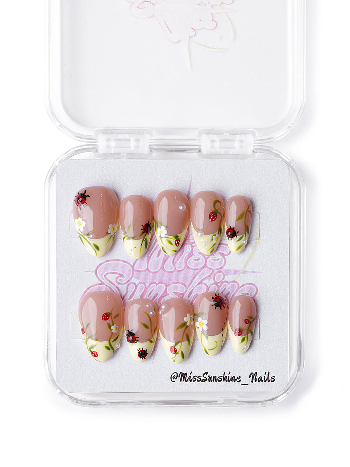 Handmade nude press on nails with garden-inspired 3D floral and insect details