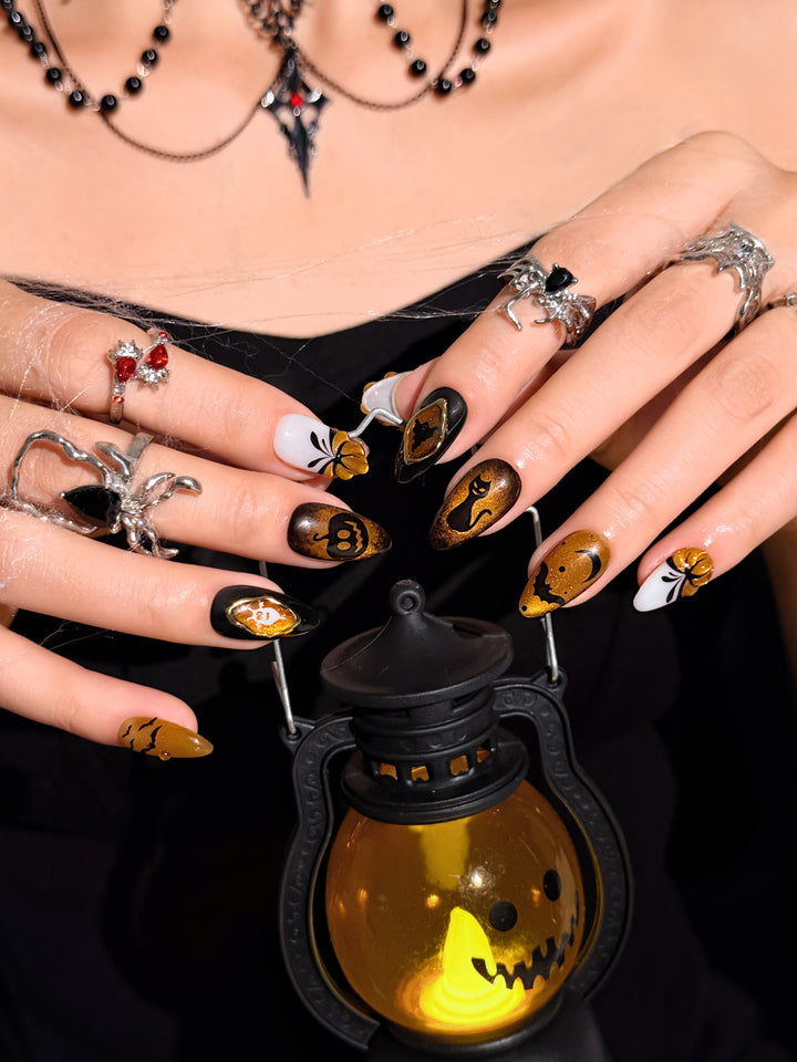 Handmade Halloween nail set featuring spiderweb, pumpkin, ghost, and black cat nail art.