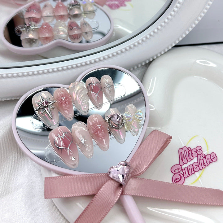 Pink nails with 3D bow and gem embellishments