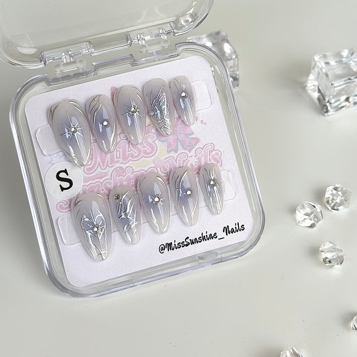 Dreamy press-on nails with hand-drawn silver lines and stars