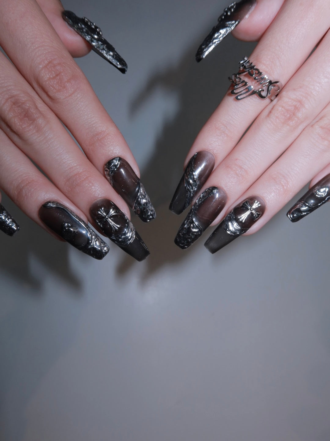 Edgy and sculptural black chrome nail set in long coffin style