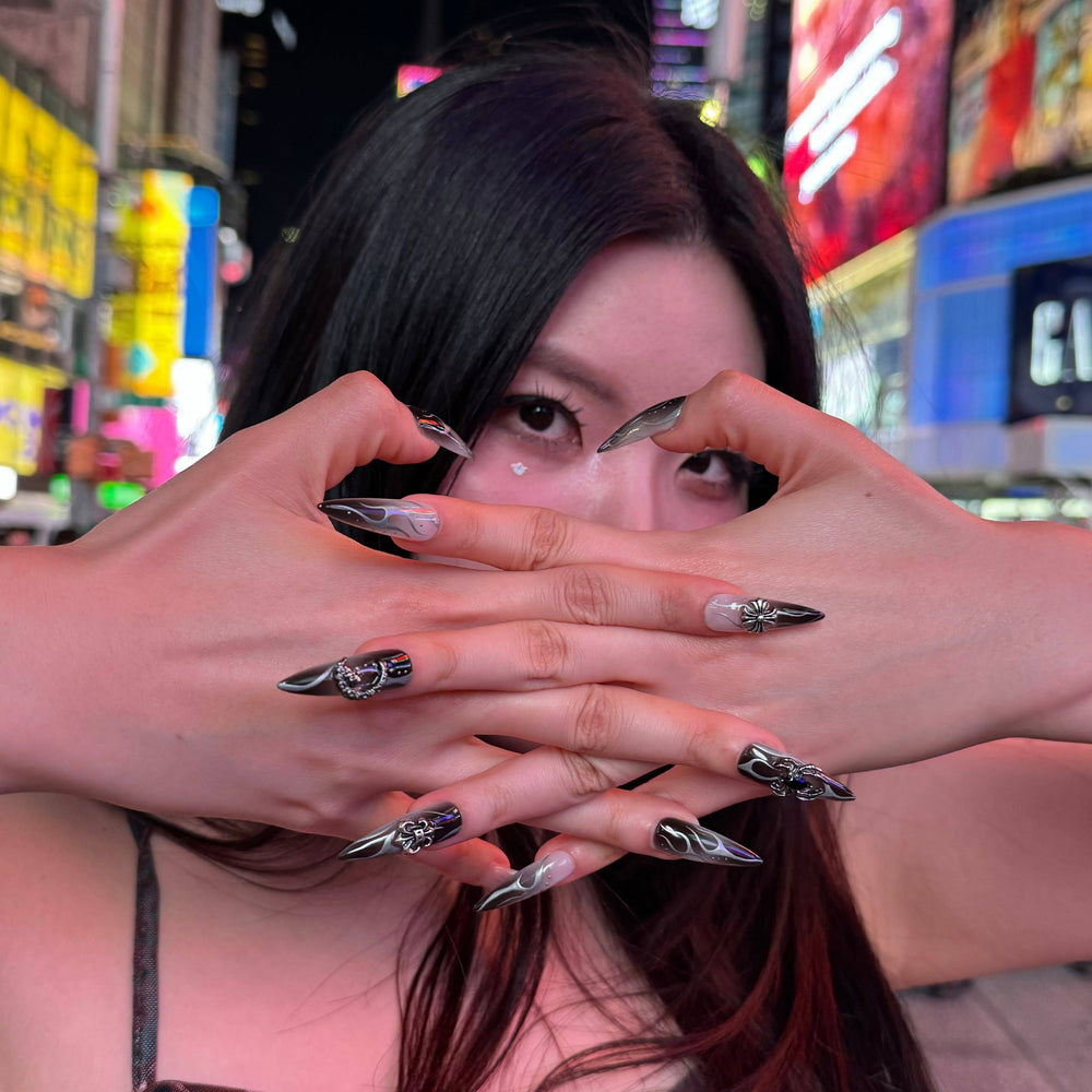 Metallic moon, cross, and rose nail art