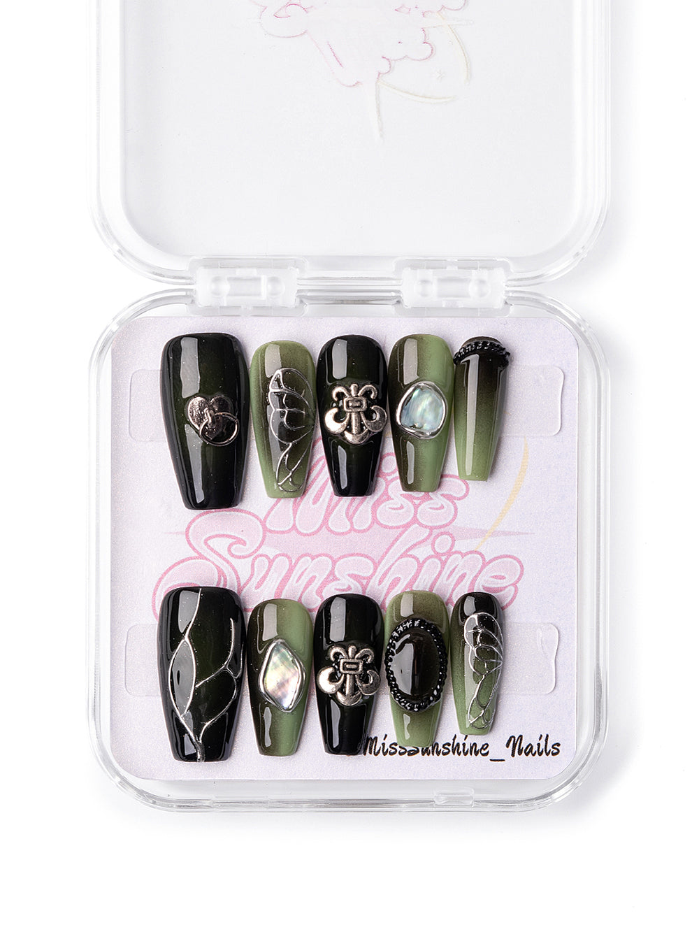 Glossy black nails with metallic bow and shell charms