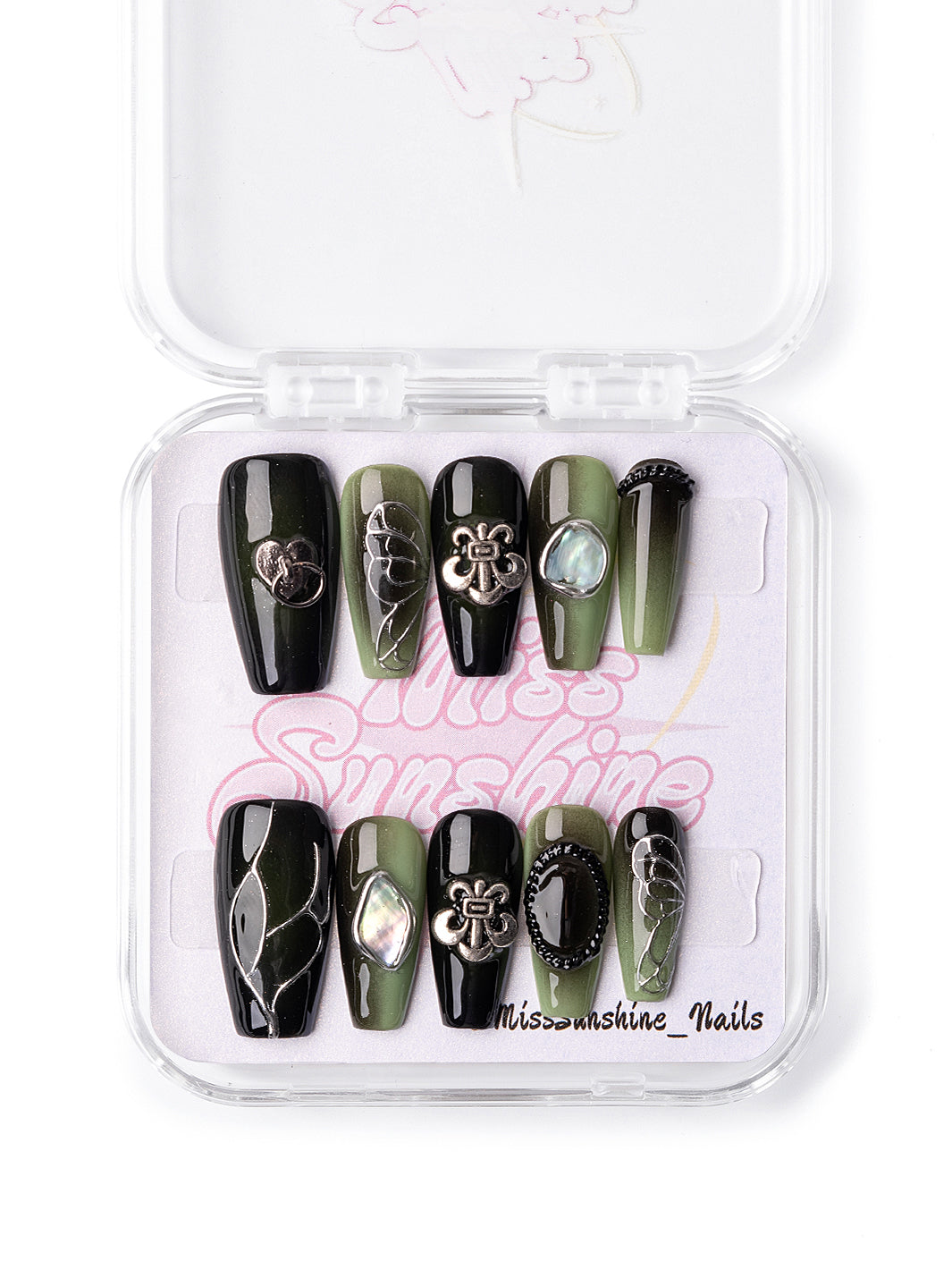 Glossy black nails with metallic bow and shell charms
