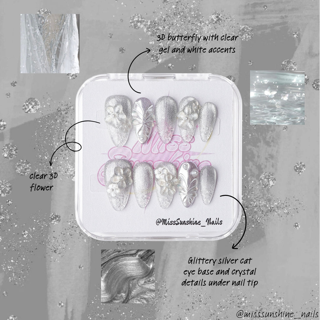 Sculptural winter press-on nail set with silver gradients, flowers, and pearlescent details