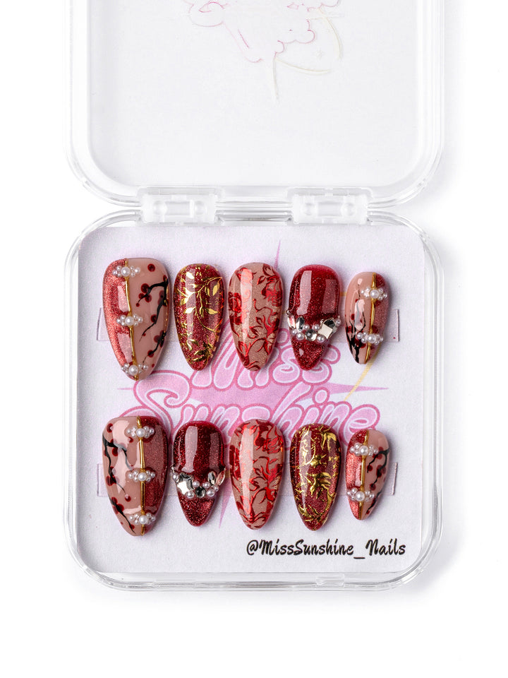 Red and gold floral short almond press-on nails inspired by Lunar New Year prosperity