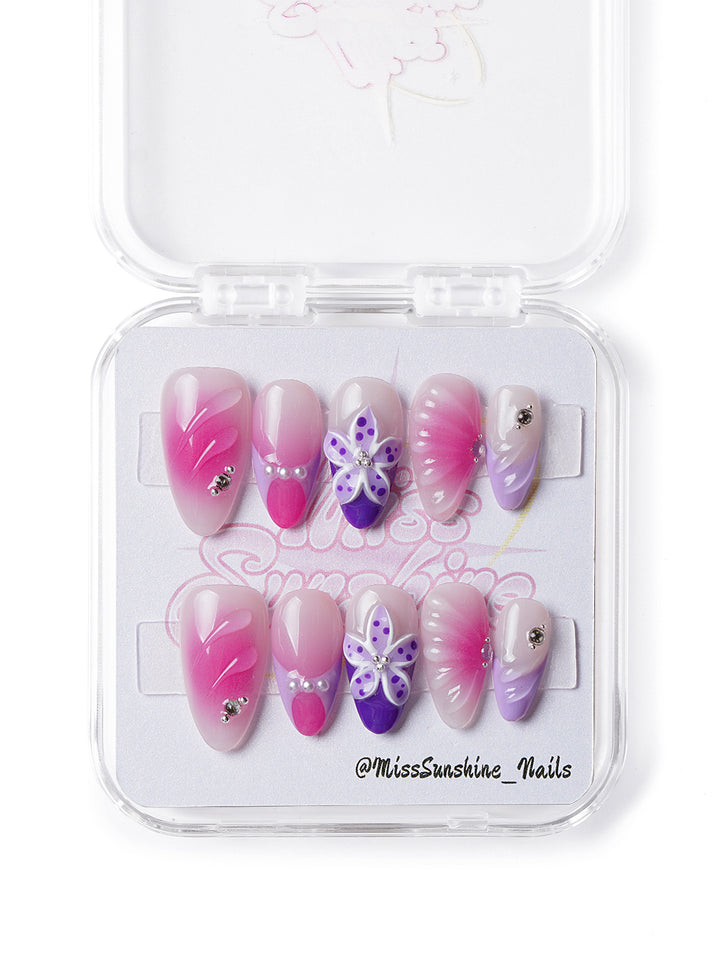 Handmade press-on nails featuring floral textures and glossy ombré gradient