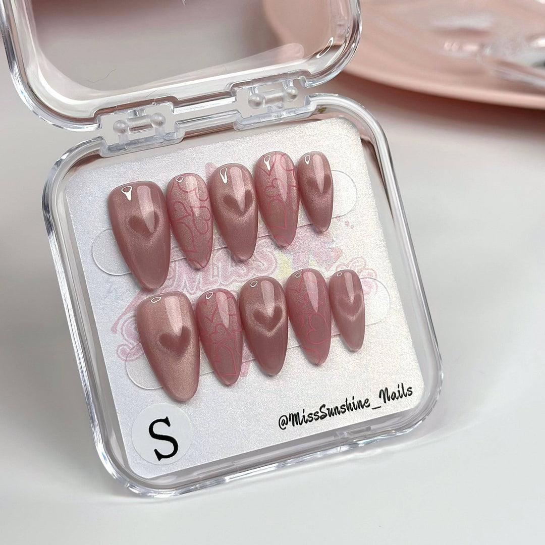 Short almond cat-eye nails with heart shimmer design