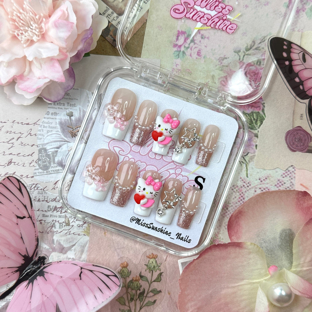 Medium-long square nails with Hello Kitty charms