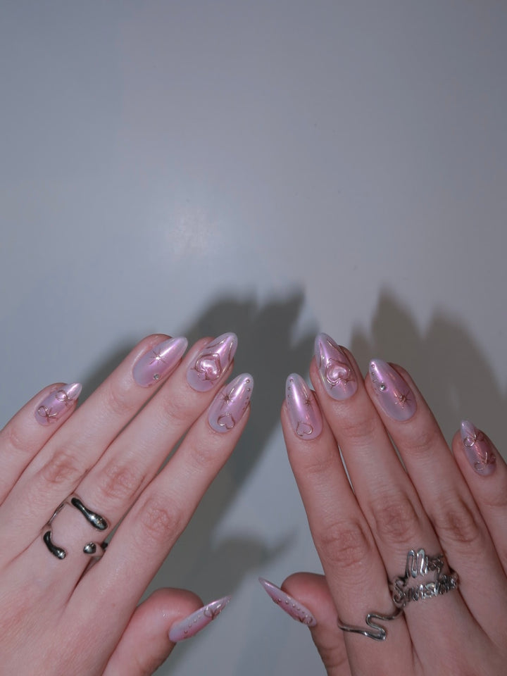 Short almond nails with stars and heart chrome designs