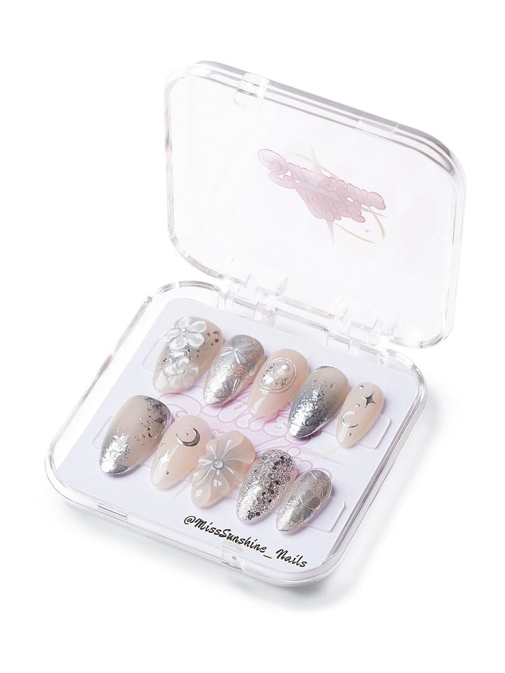 Short almond nails with silver chrome tips and 3D flowers