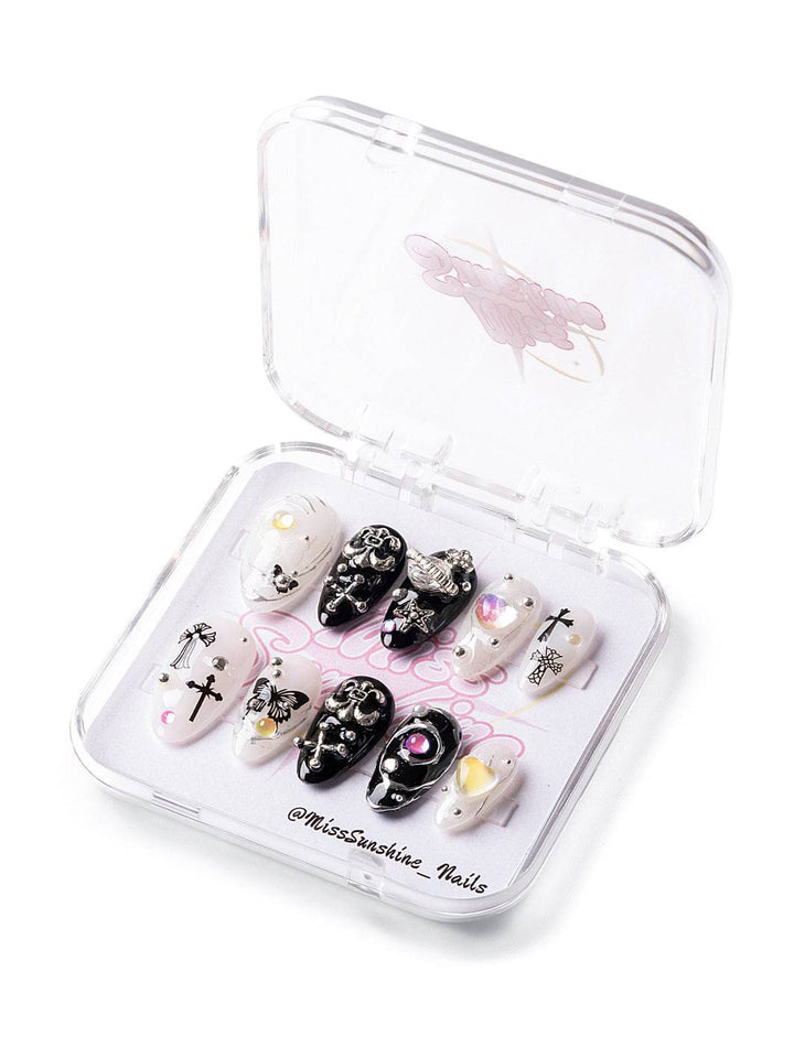 Short almond nails with crosses and celestial charms