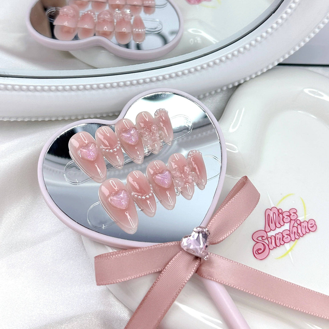 Short almond jelly nails with 3D hearts and pearls