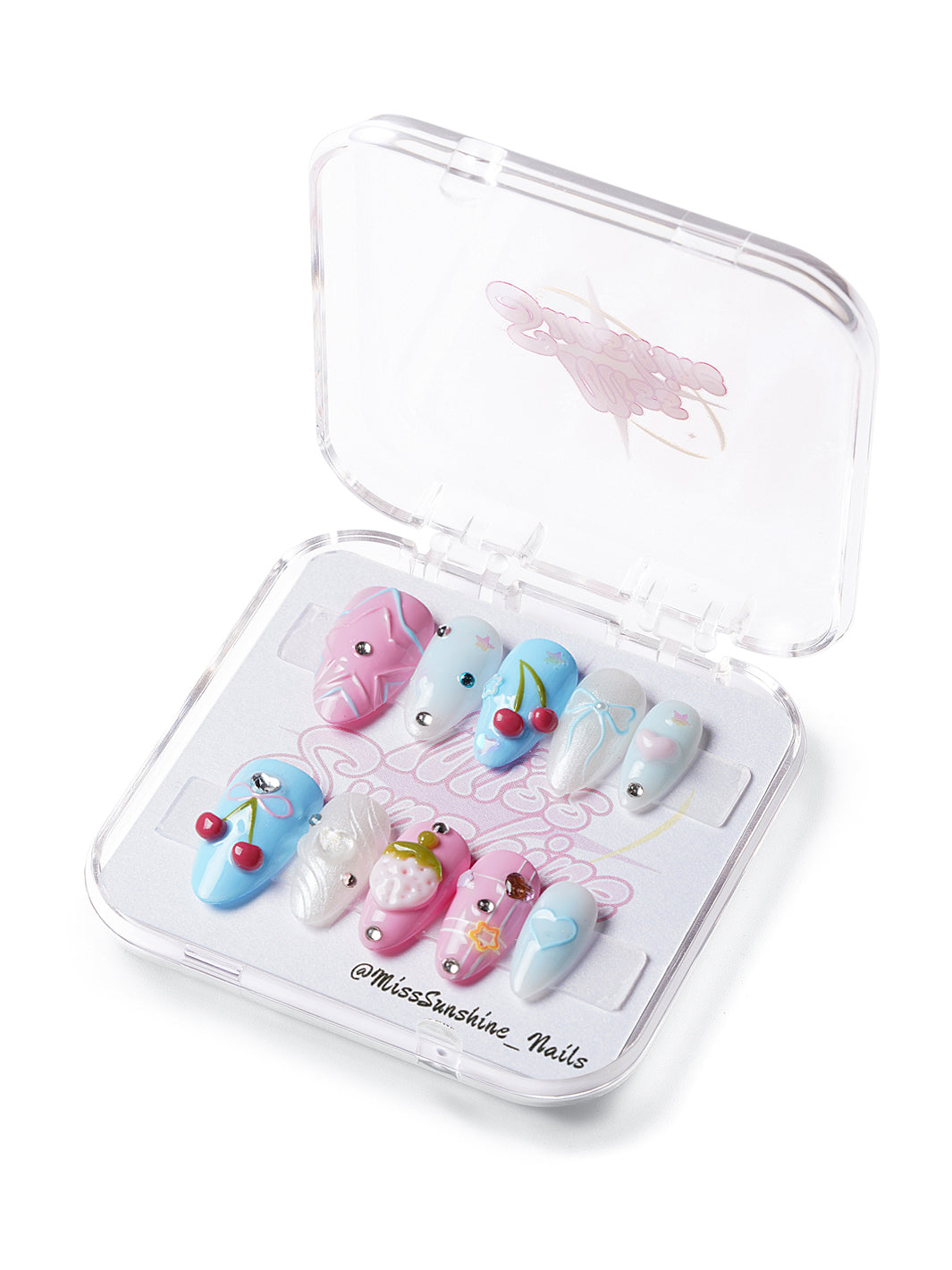 Press-on nails with 3D cherries, hearts, bows, and stars in pastel pink, blue, and white with rhinestones