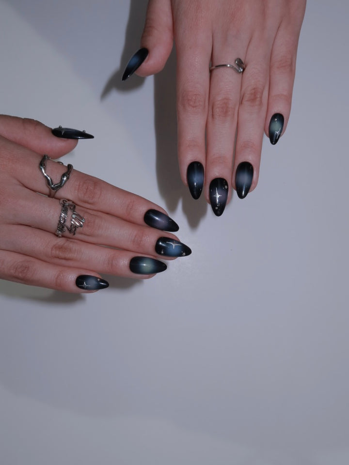 Night sky nail art with starburst details
