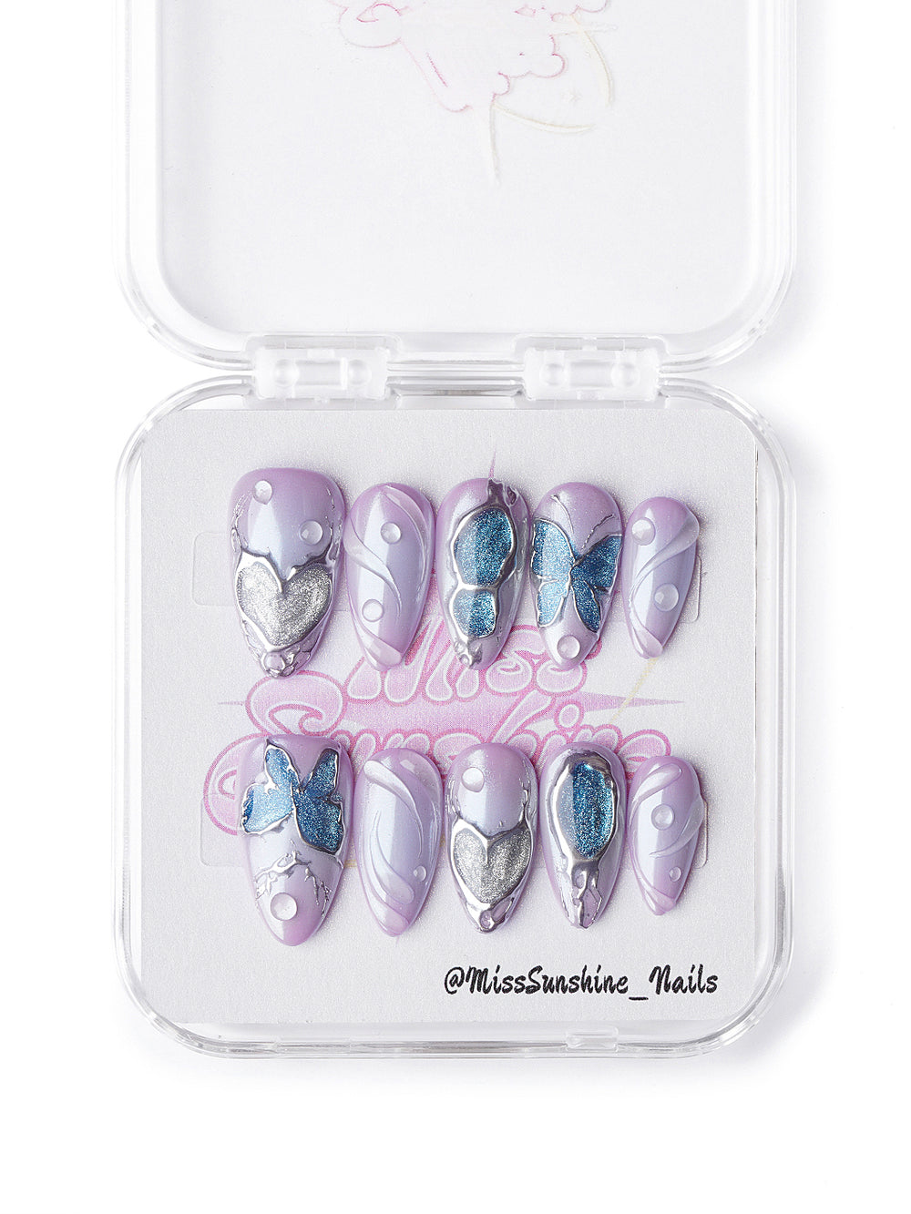 Short almond lavender nails featuring 3D butterflies, sculpted silver hearts, and pastel gradients