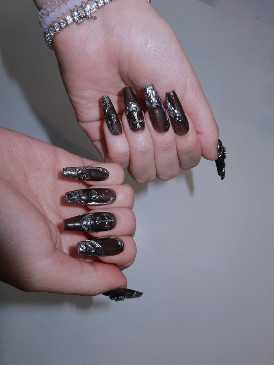 Luxury press-on nails with silver textures and matte black finish