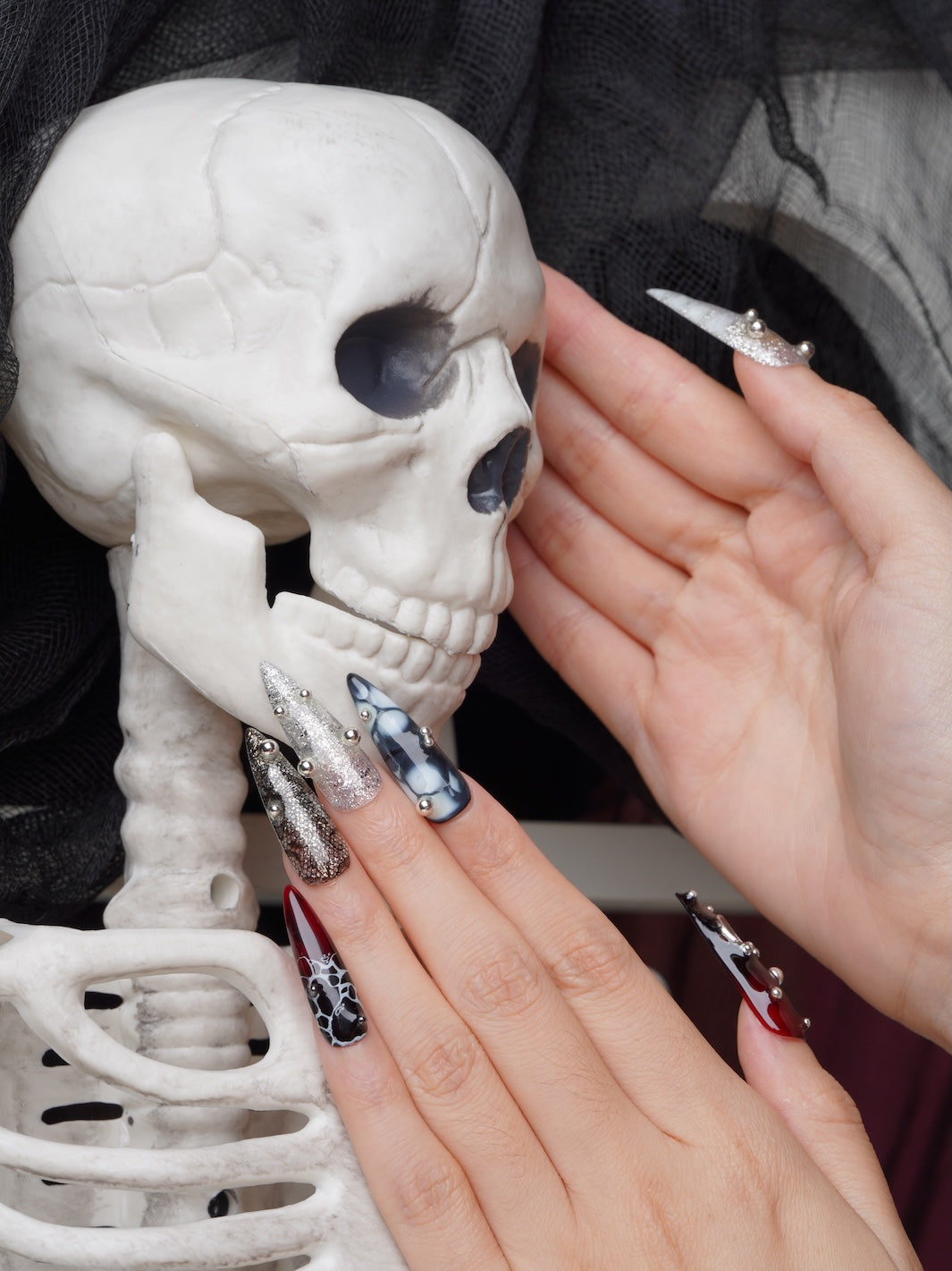 Edgy press-on nails with piercings, marble, and sparkle