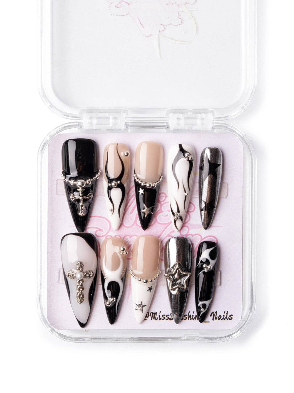 Gothic-inspired press-ons with flame art, chrome finishes, and edgy star detailing