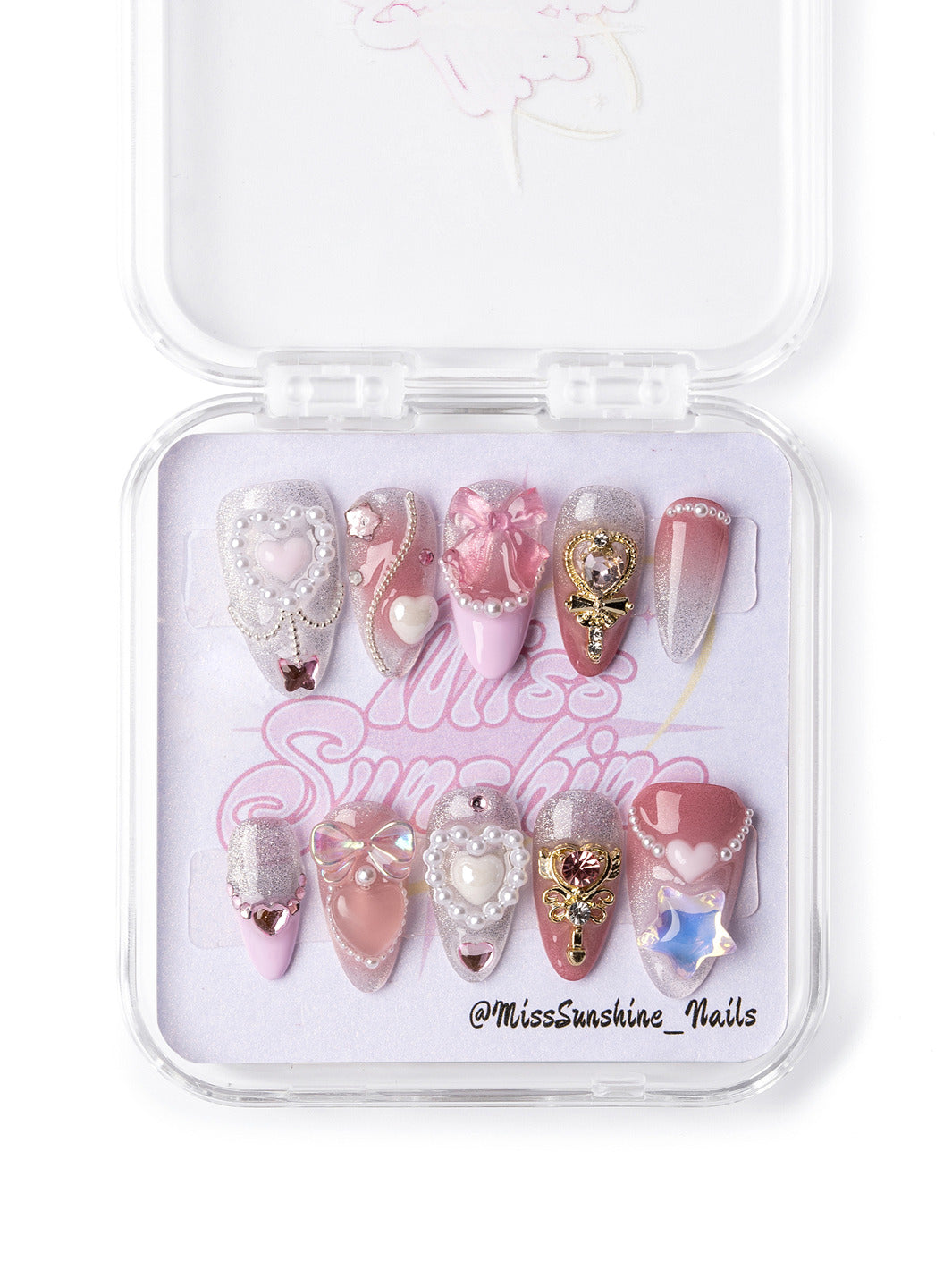 Valentine’s Day press-on nails in soft pink with glitter, bows, and luxurious 3D heart designs.