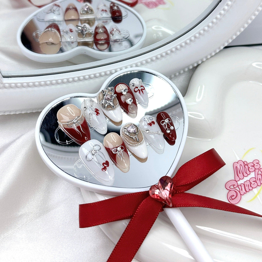 Red and white nails with heart charms