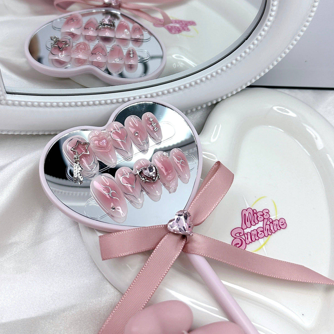 Pink almond nails with heart outline art