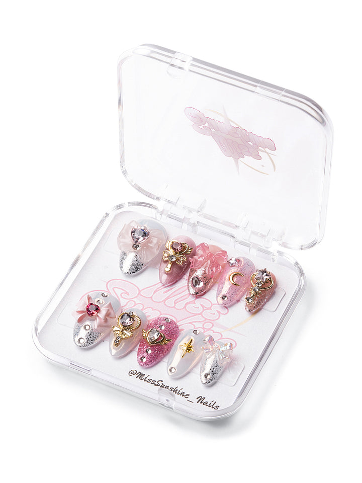 Glitter nails with moons and heart charms