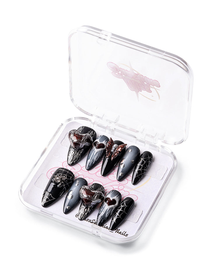 Black ombré nails with red heart charms