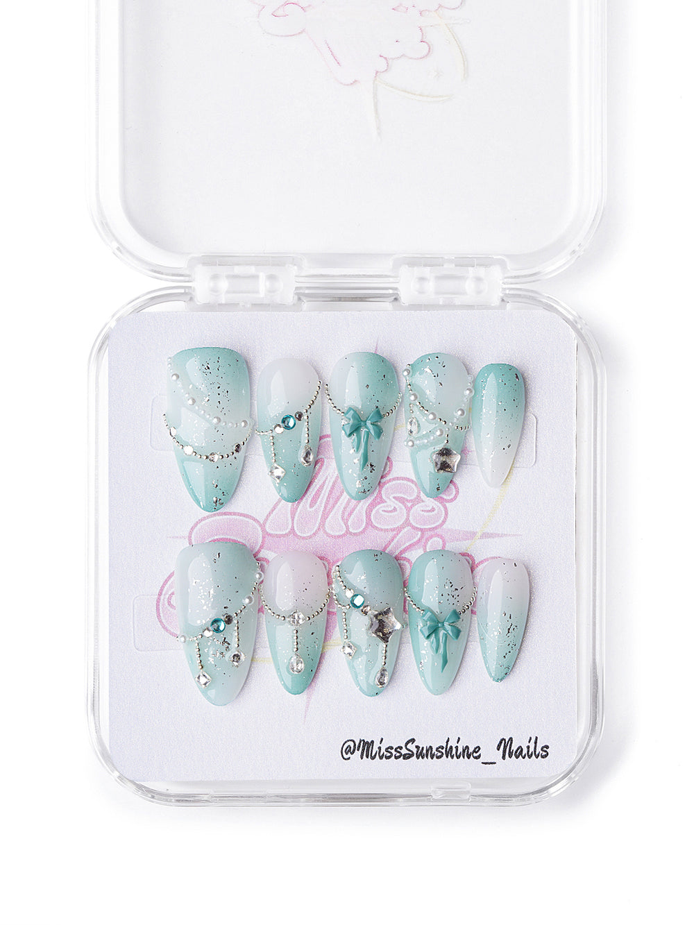 Mint and white short almond celestial nails with glitter, bows, and silver charms