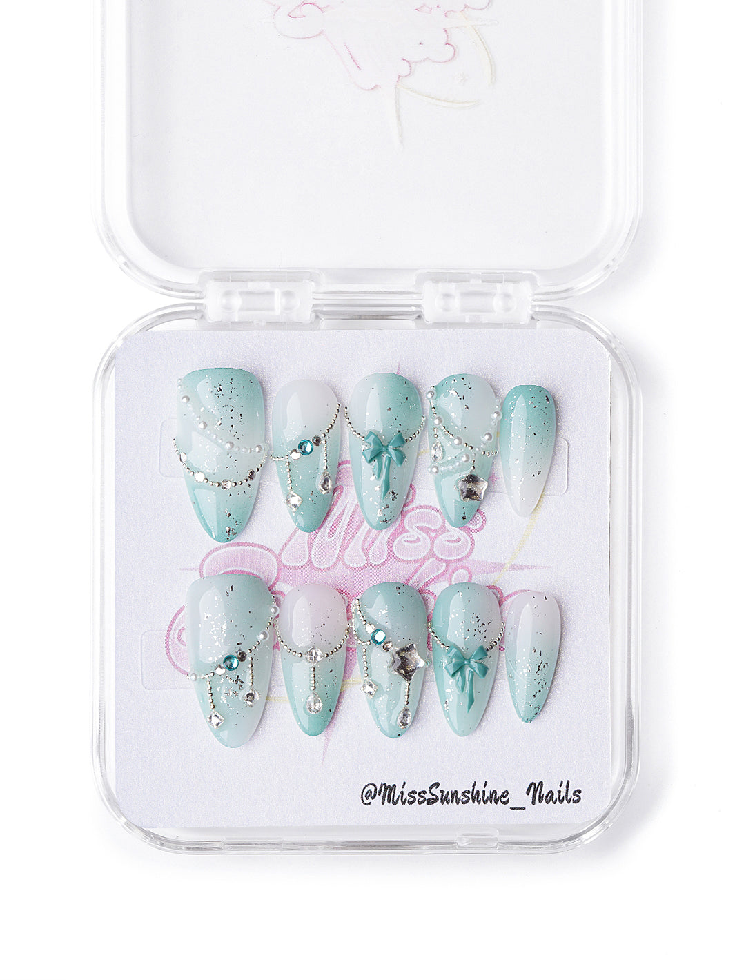 Mint and white short almond celestial nails with glitter, bows, and silver charms