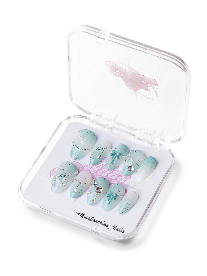 Mint Starfall short almond press-on nails with icy mint gradients, stars, chains, and gemstone accents