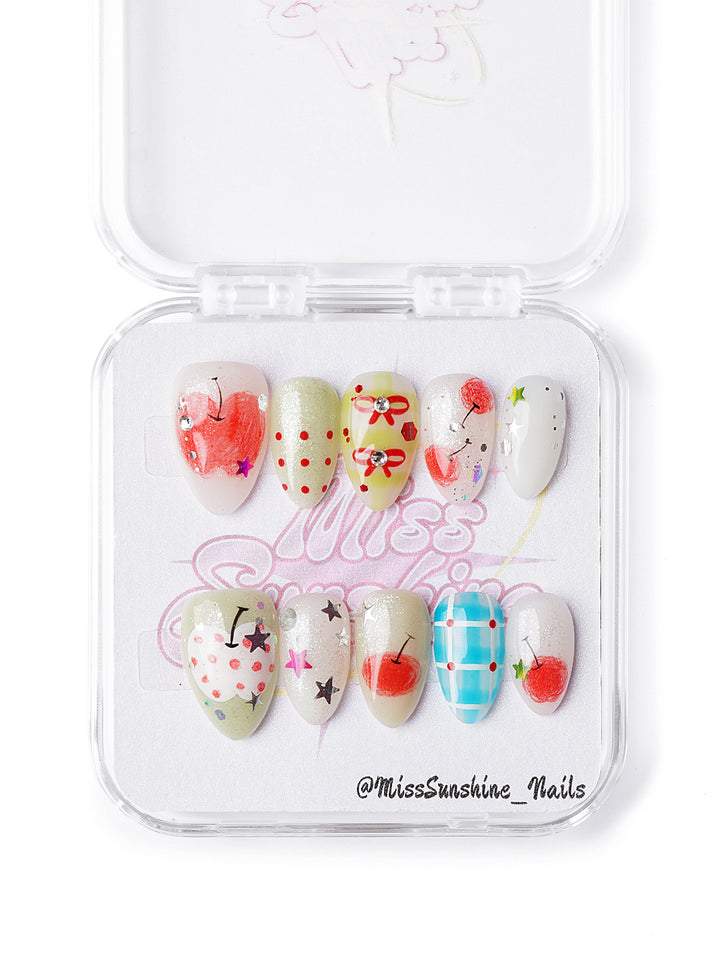 Handmade apple-themed nails with bows, stars, checkers, and red-green fruit accents in extra short almond shape