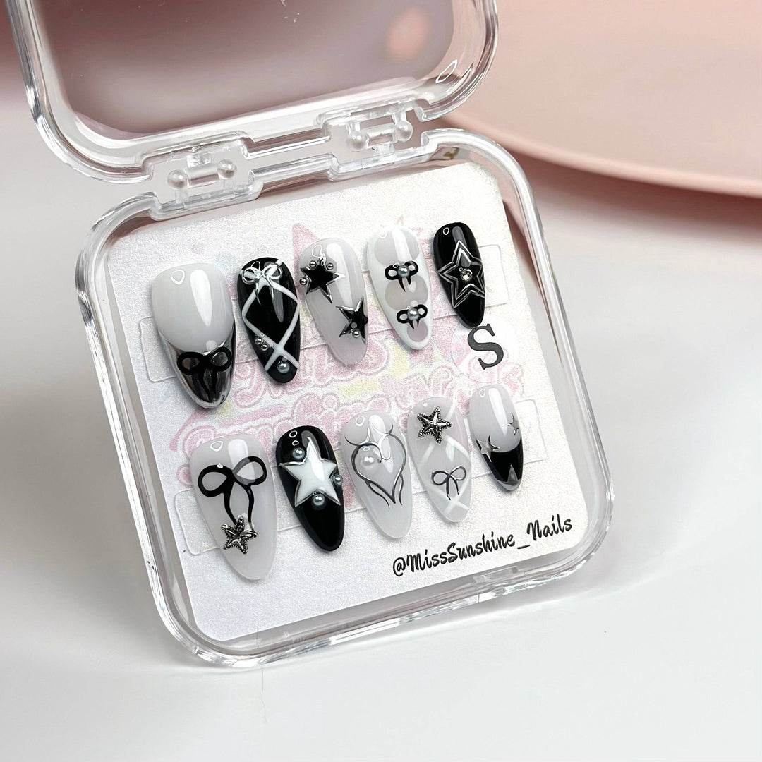 Handmade press-on nail set with pearl and metallic bow accents