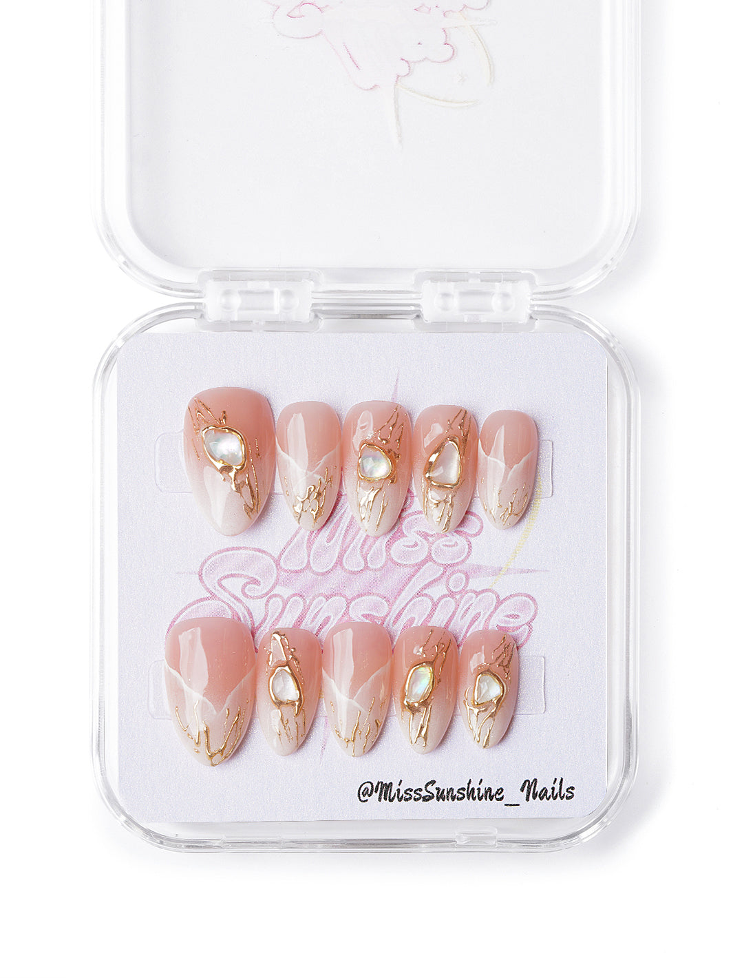 Handmade short almond nails with gold swirls, soft white waves, and gem-like accents