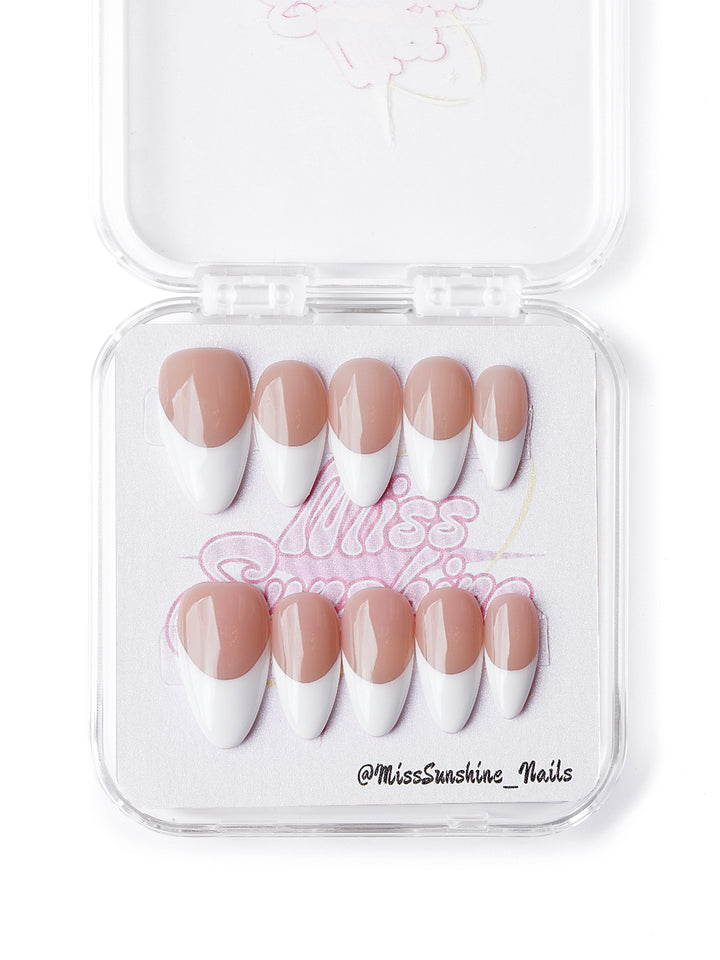 Classic French tip press-on nails in short almond shape with white tips and nude base
