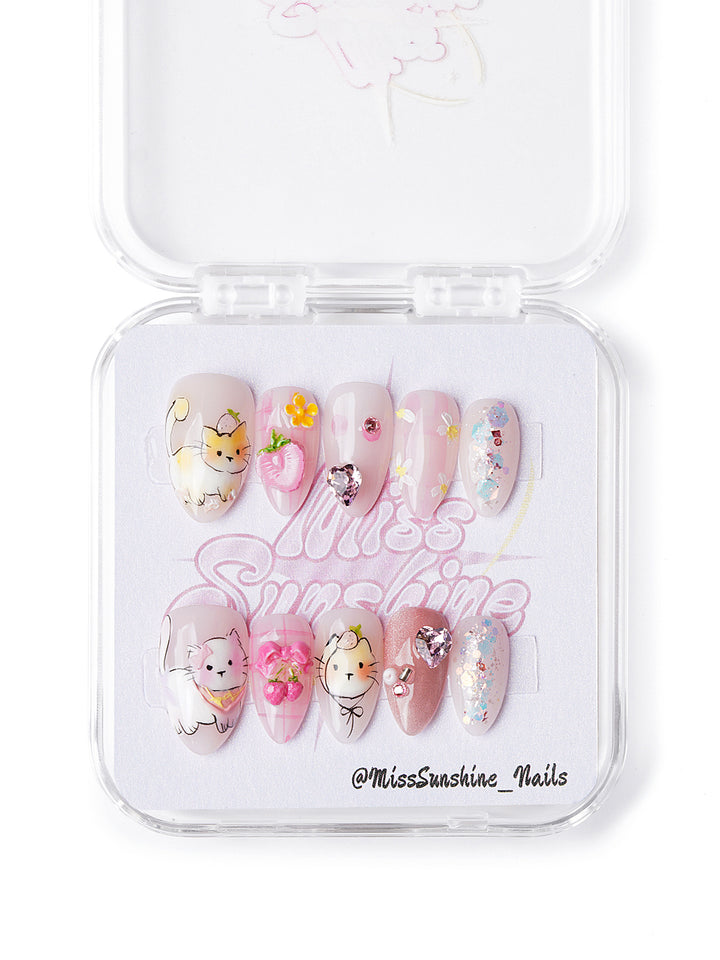 Handmade kawaii nails with cat designs, fruit charms, sparkle hearts, and gingham accents