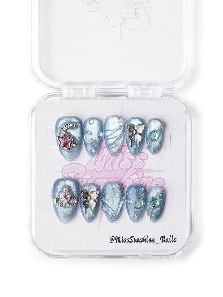 Blue celestial extra short press-on nails featuring sculpted textures and gemstone accents