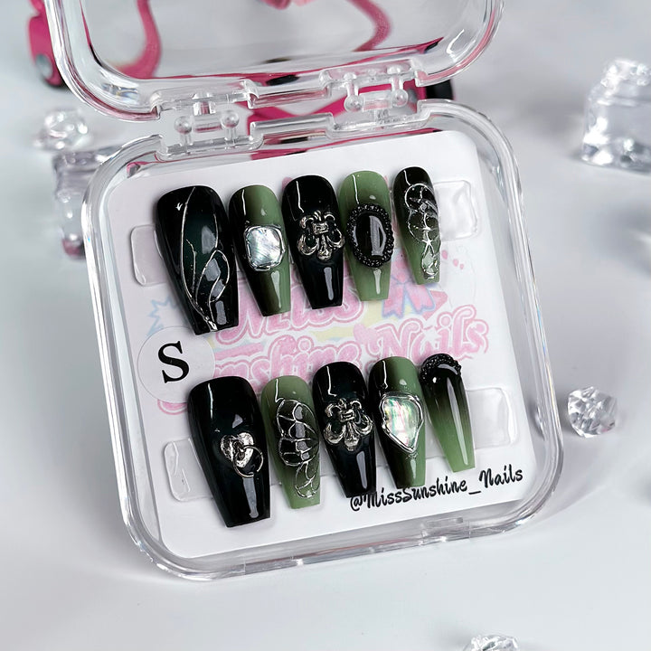 Hand-painted green nails with leaf details and 3D art