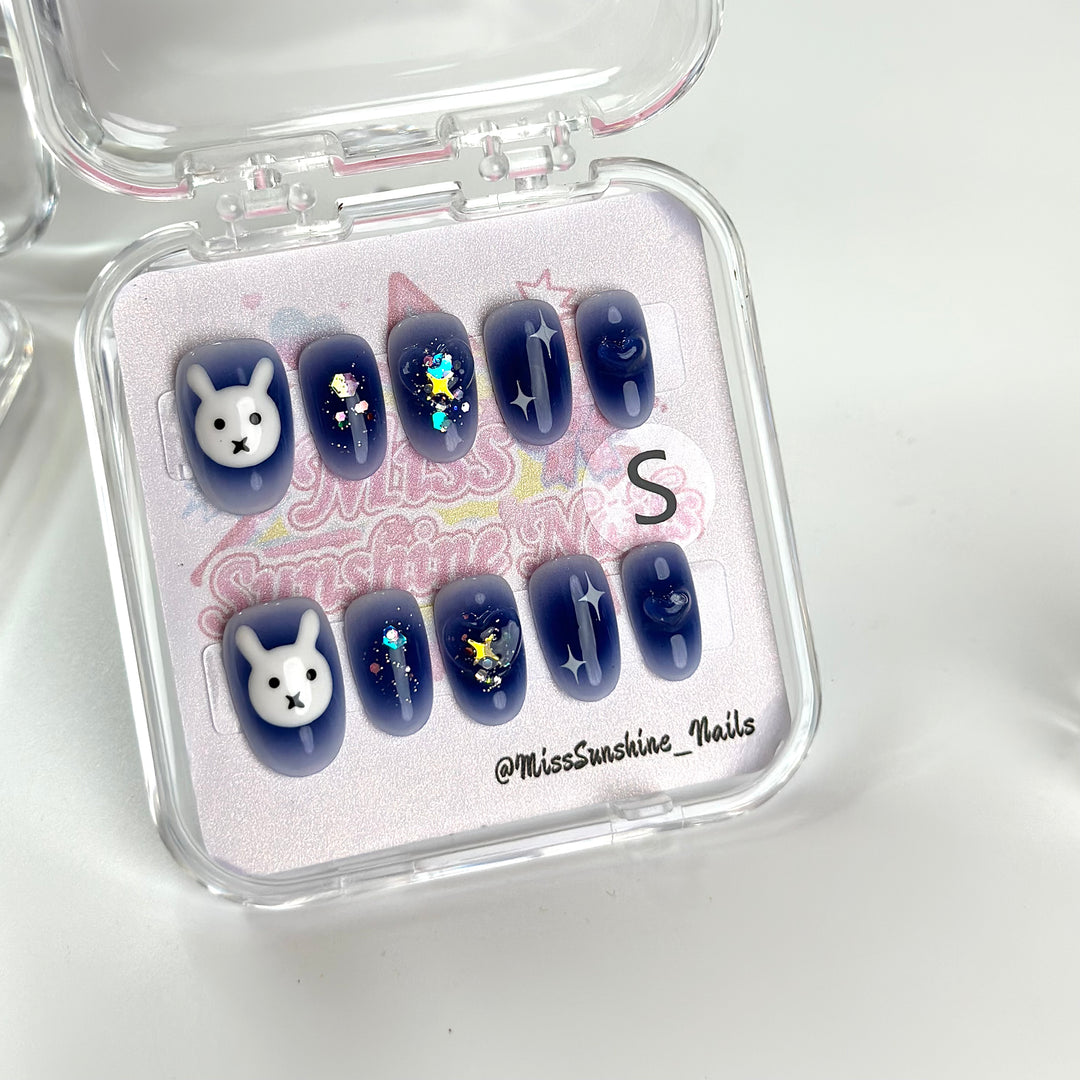 Blue oval nails with hearts and pearls