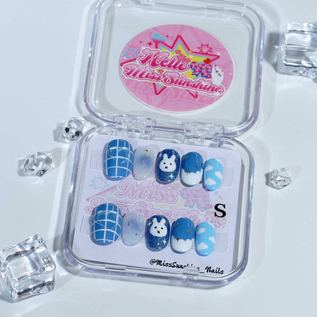 Blue nails with bunny and cloud designs