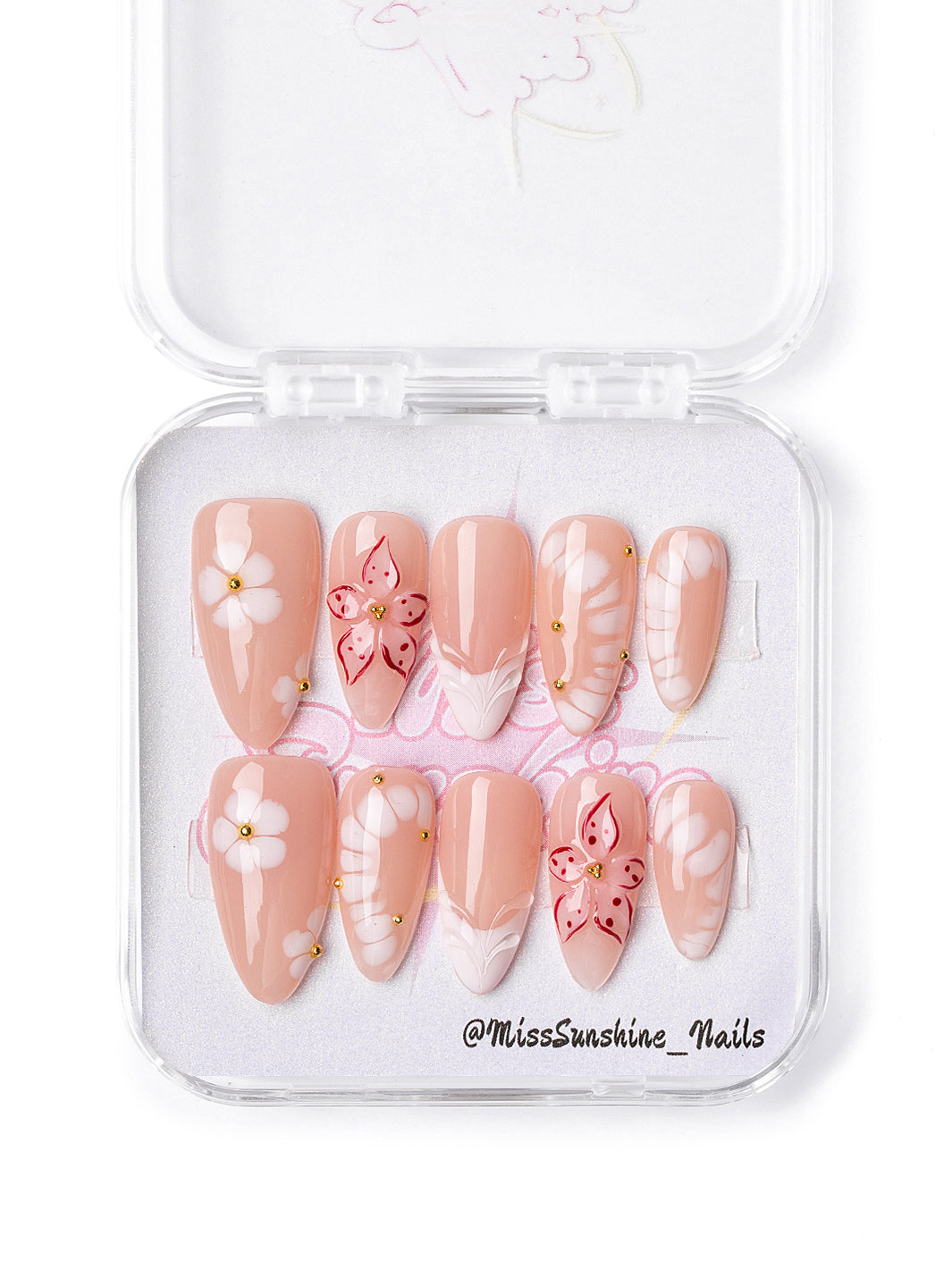 Nude Plumeria press-on nails with tropical floral accents and gold details