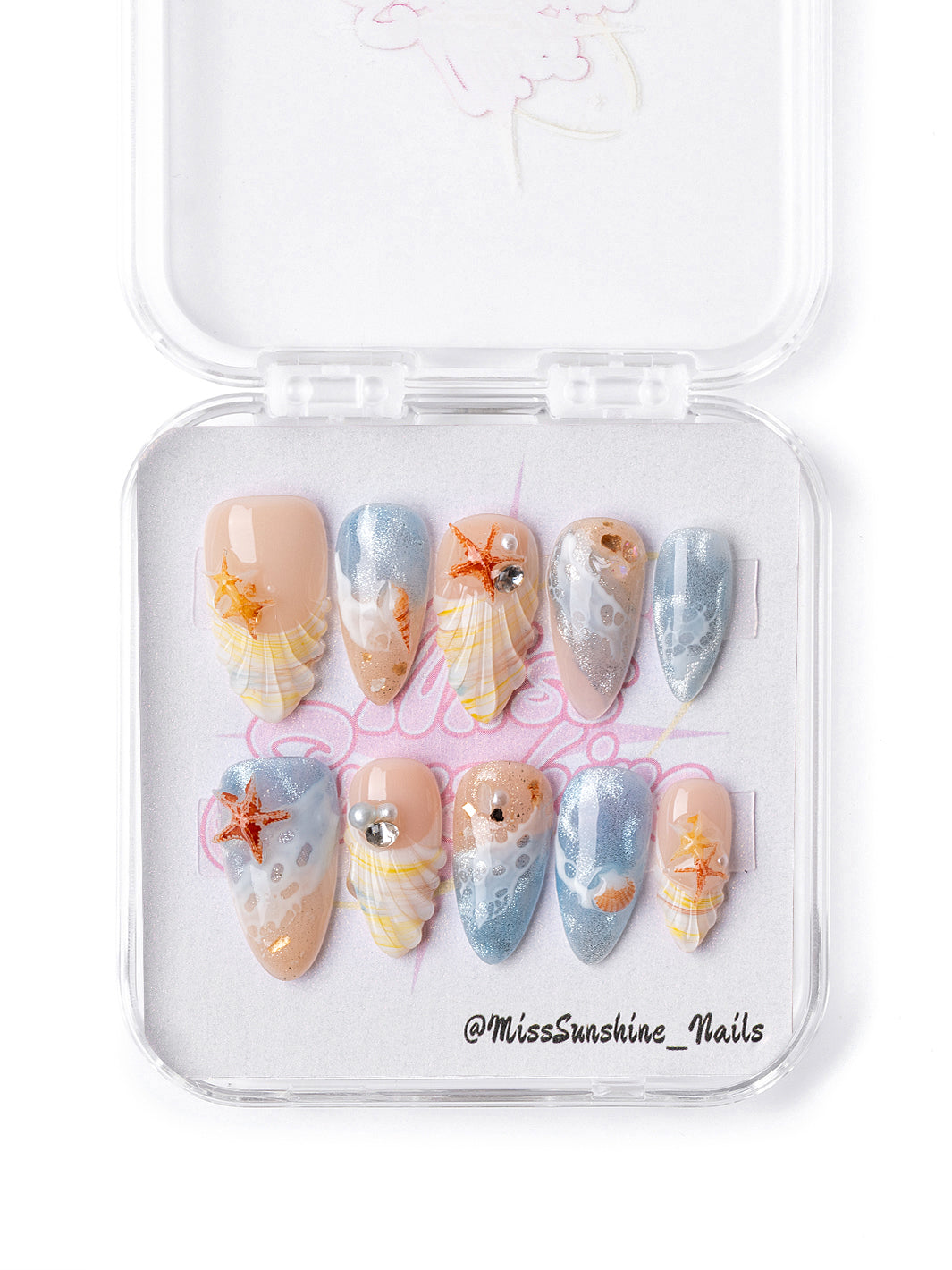 Ocean Kiss press-on nails featuring 3D orange starfish charm details
