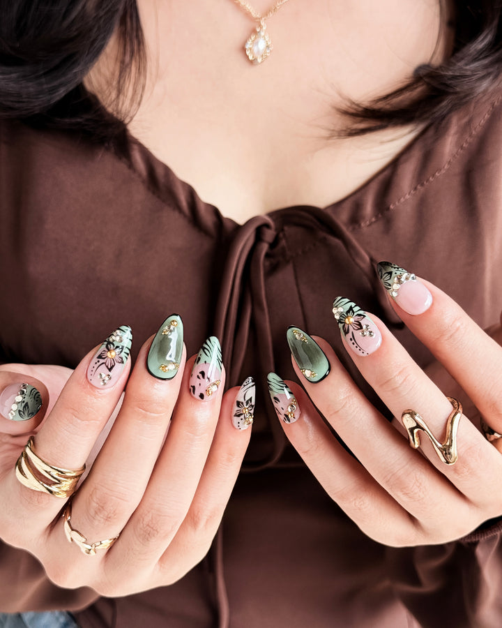 Handmade almond nails with olive green tones, delicate flowers, and elegant fall details