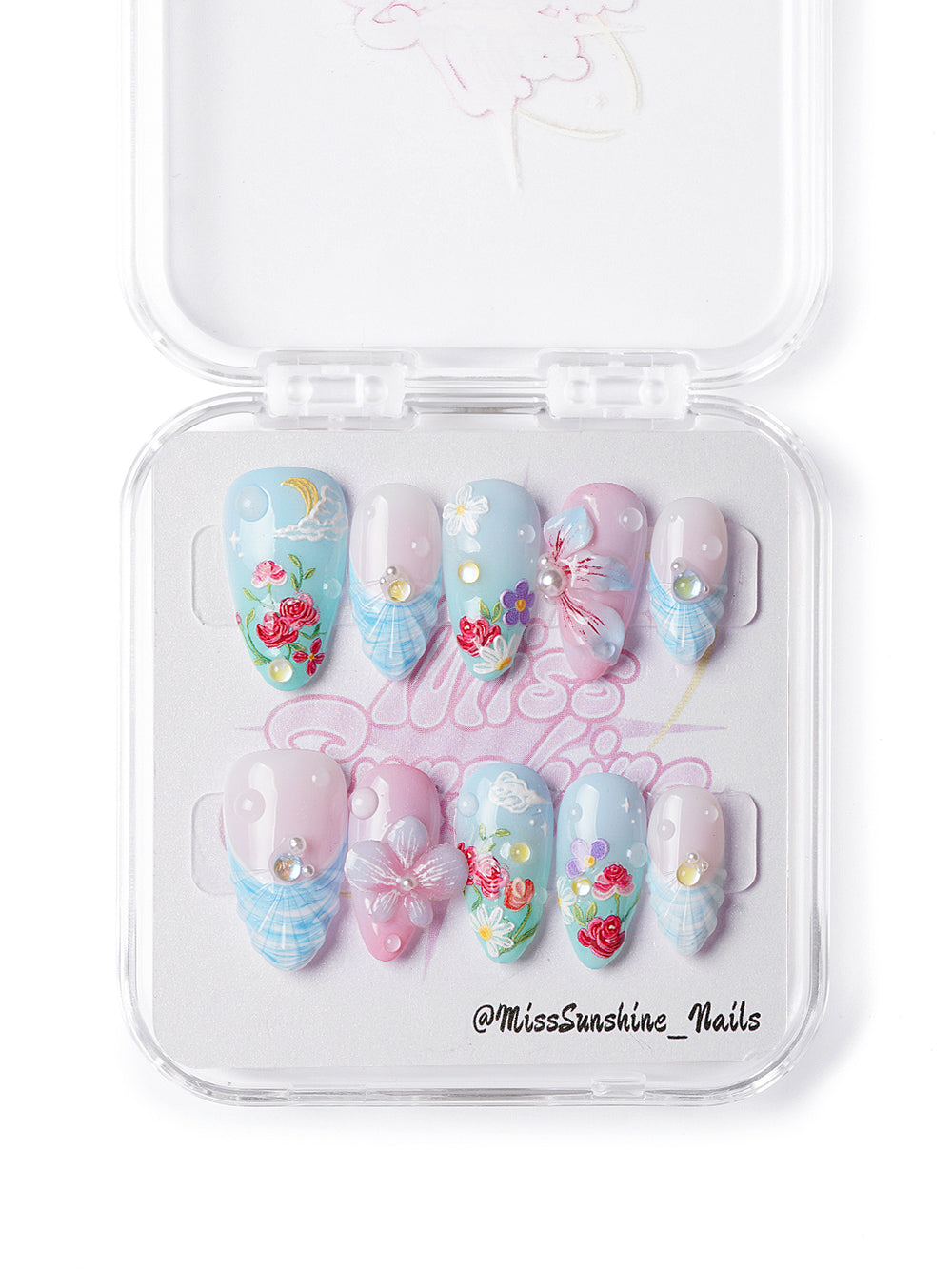Handmade dreamy spring nails with 3D flower and butterfly accents over a blue-pink gradient base