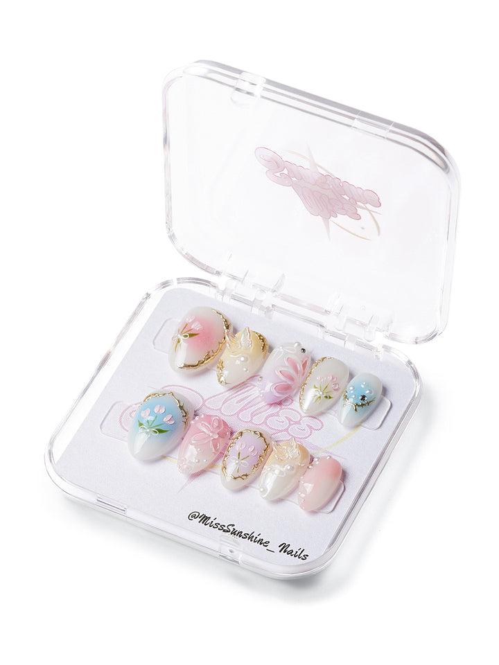 Extra short almond nails with pastel tulips, pearls, and gold-framed floral accents