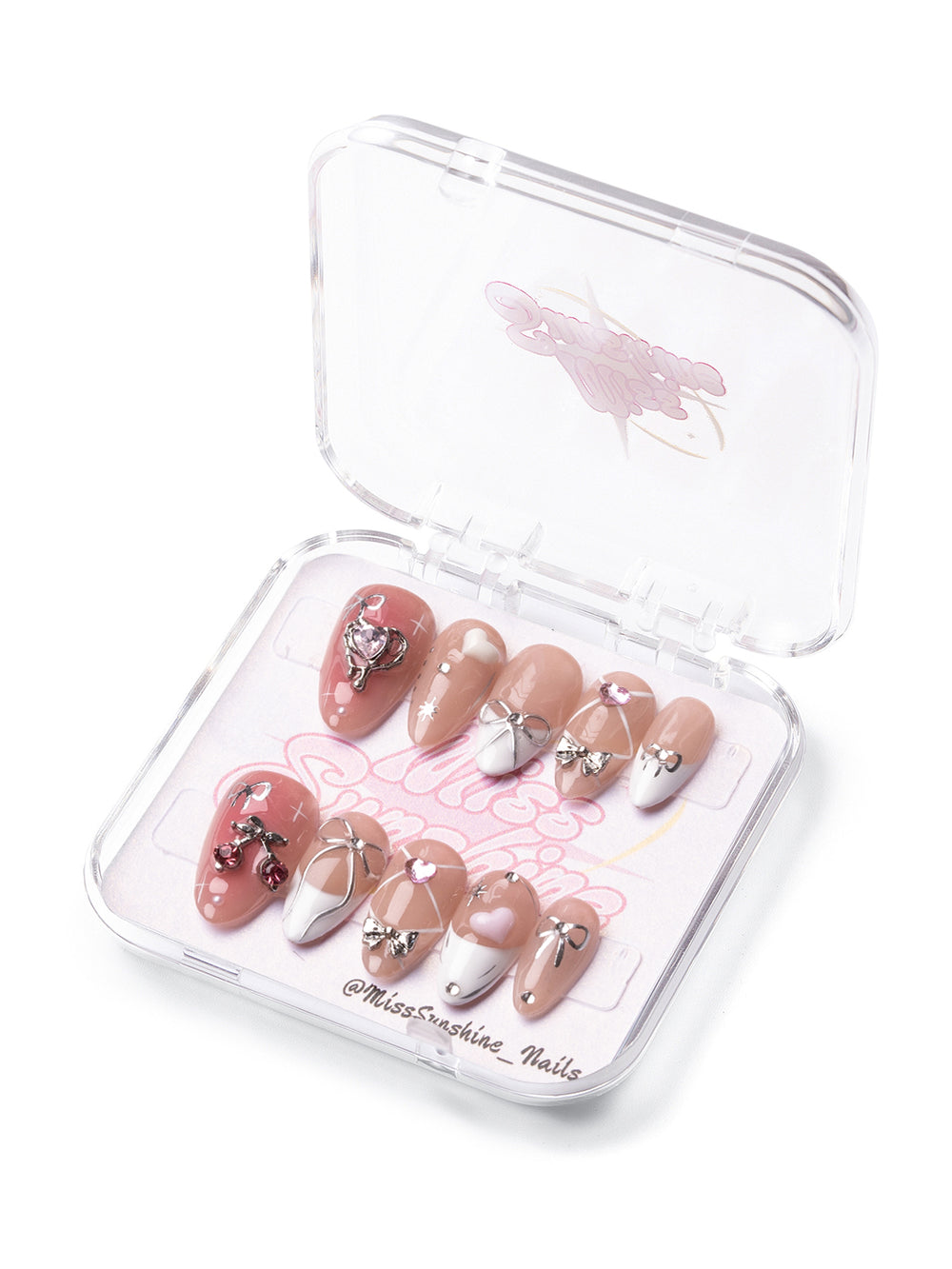 Blush pink girly press-on nails with white tips and metallic charms