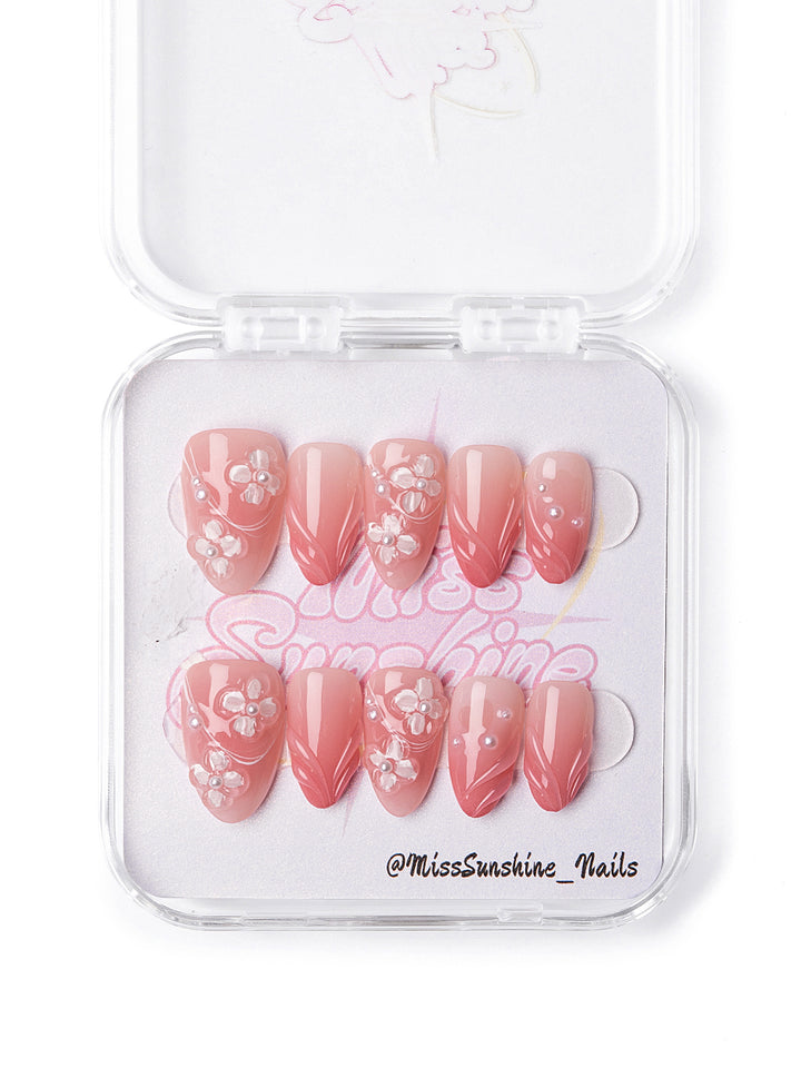 Blush pink press-on nails with hand-sculpted flowers