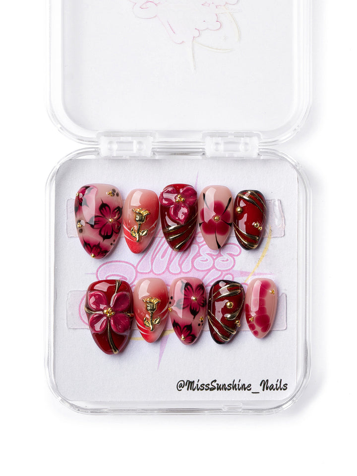 Poison Flower nails featuring gold roses and black swirl accents.