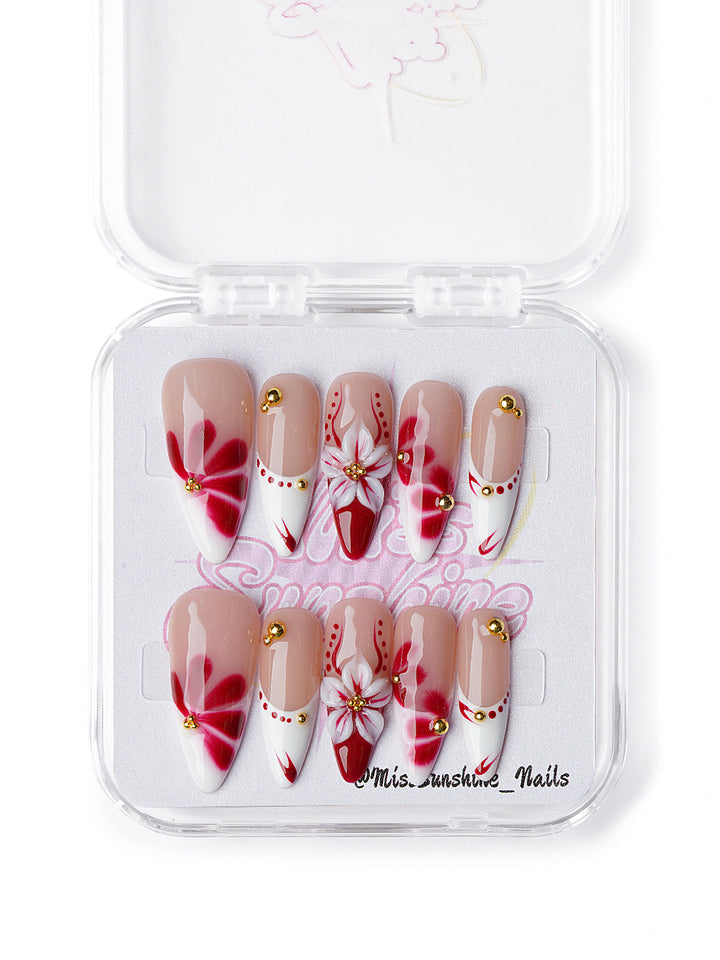 Handmade press on nails with red floral art and elegant gold accents